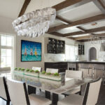 A dining room with a glass table and white chairs