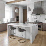 A kitchen with white cabinets and wooden floors