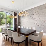 A large dining room table with white chairs