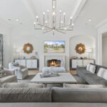 A living room with couches, chairs and a fireplace.