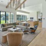 A living room with couches, chairs and tables.